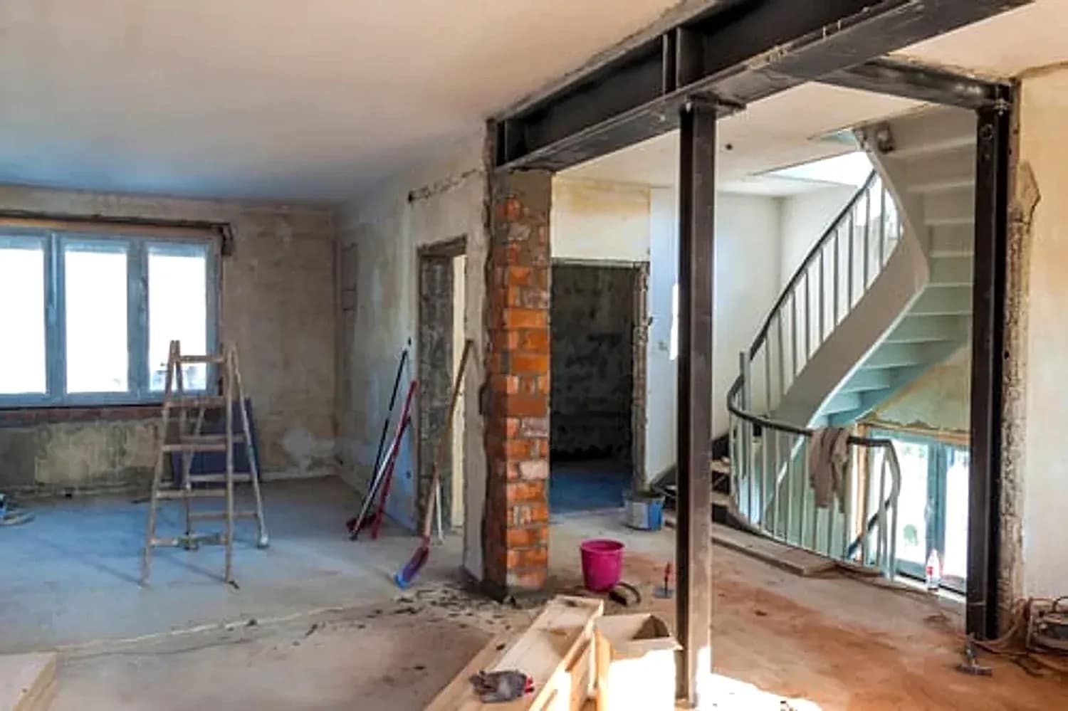 Interior of a Washington DC row house stripped to structure with steel support beams during a gut renovation