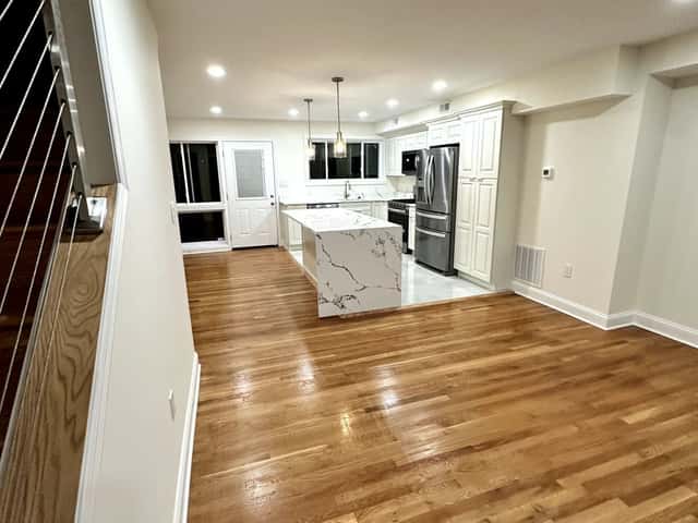Open-plan kitchen and living area with refinished oak hardwood floors