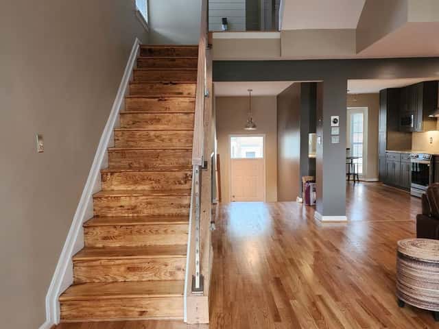 Refinished hardwood staircase and floors in a whole-home renovation