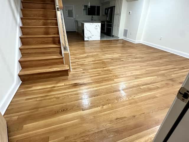 Refinished oak hardwood floors and staircase in a renovated living space