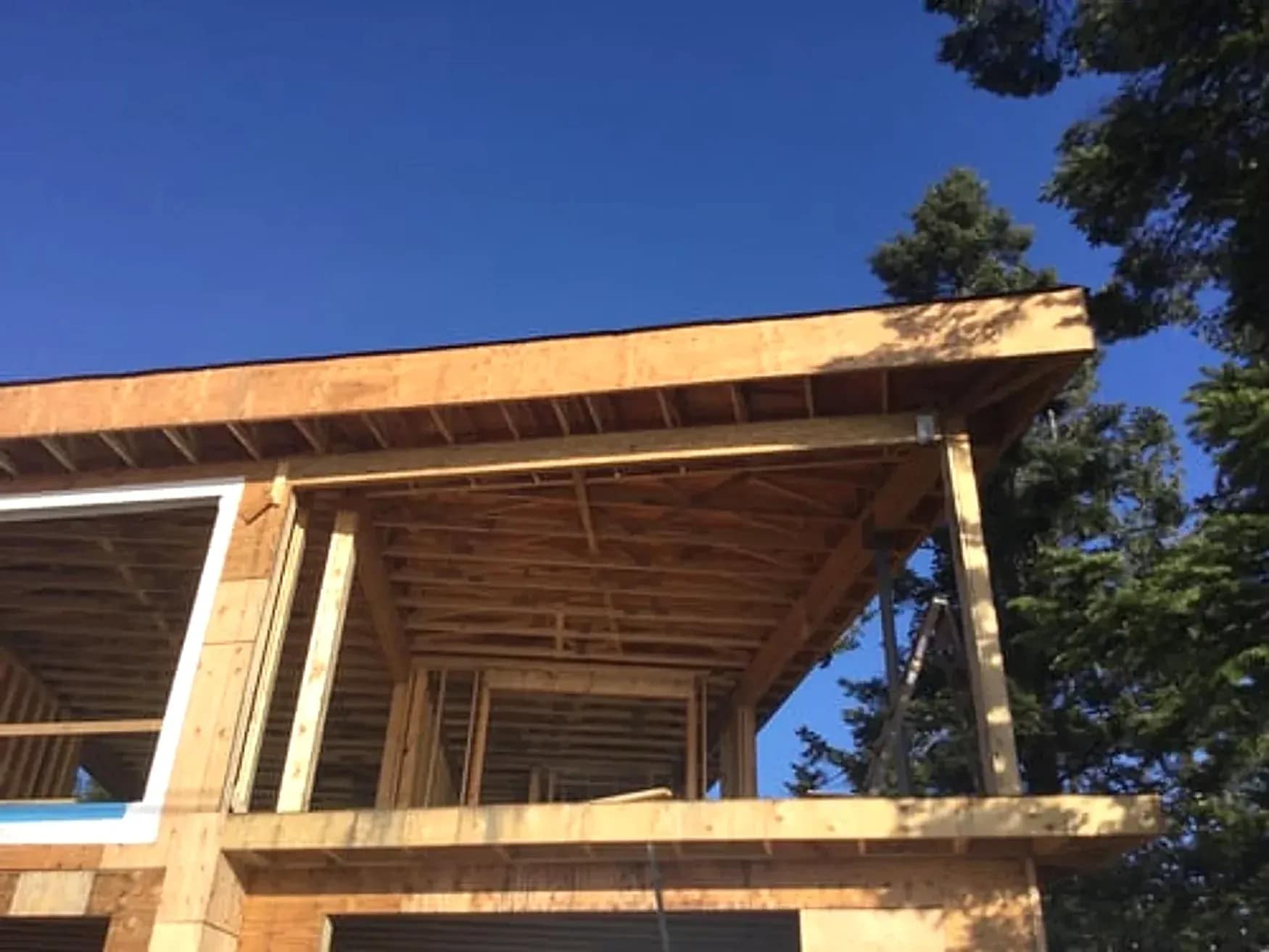 Framed rear home addition under construction in Northern Virginia by Falcon DMV Construction
