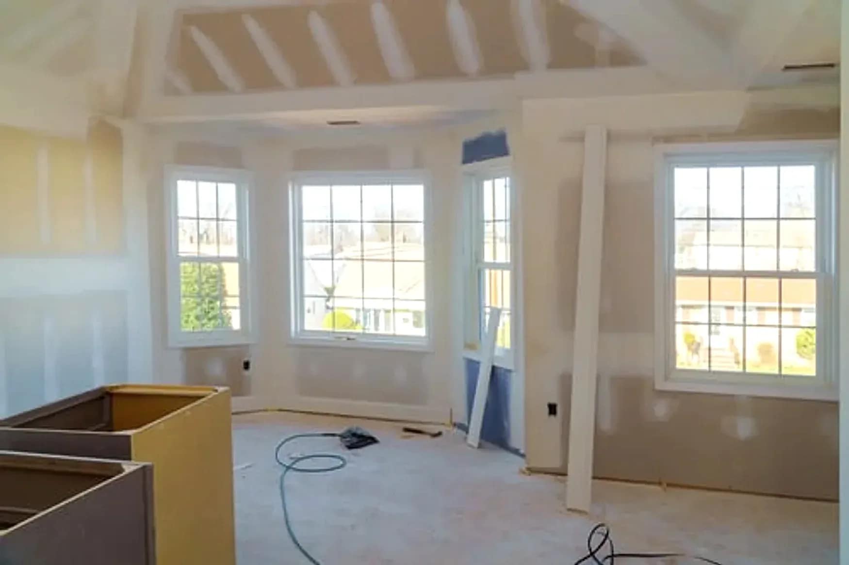 Whole-home remodeling project in the DMV with newly framed and drywalled open living space by Falcon DMV Construction